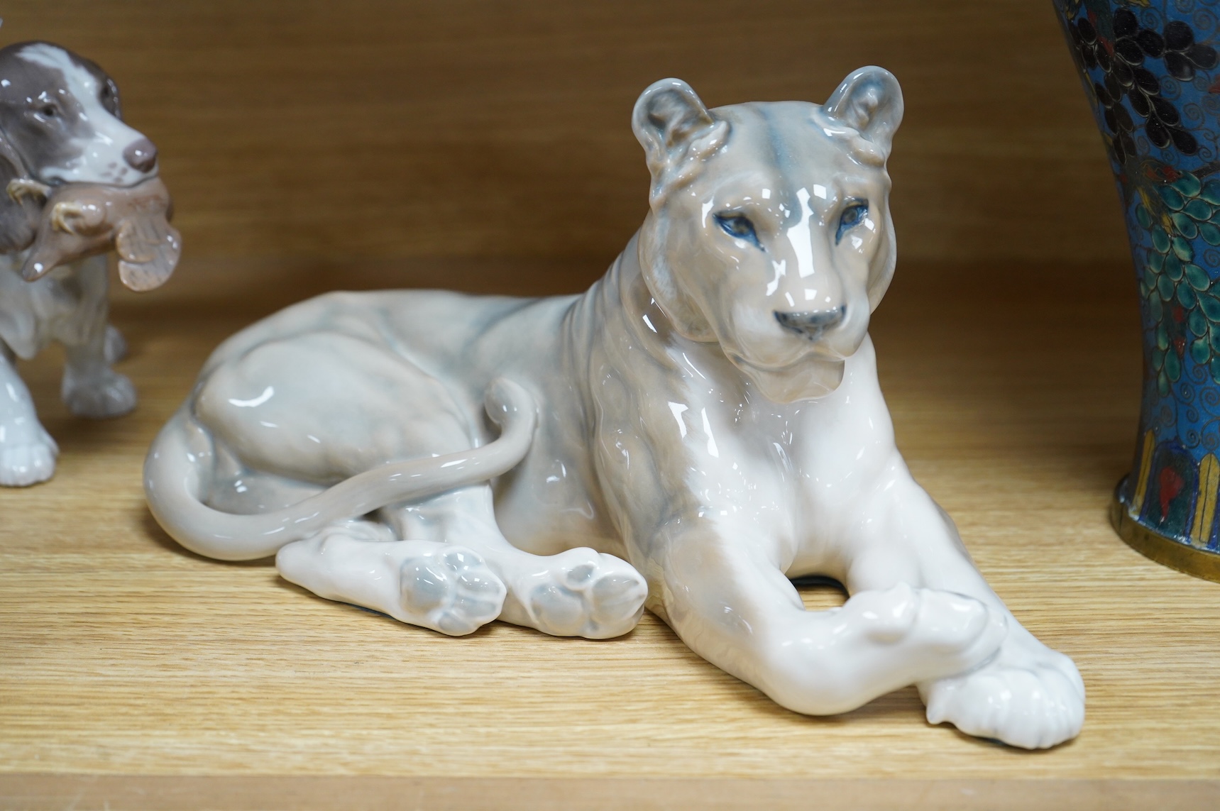 A Royal Copenhagen figure, 'The Sandman', Number 1129, a similar cat, number 340, a B&G spaniel and a Danish lion, tallest 18.5cm